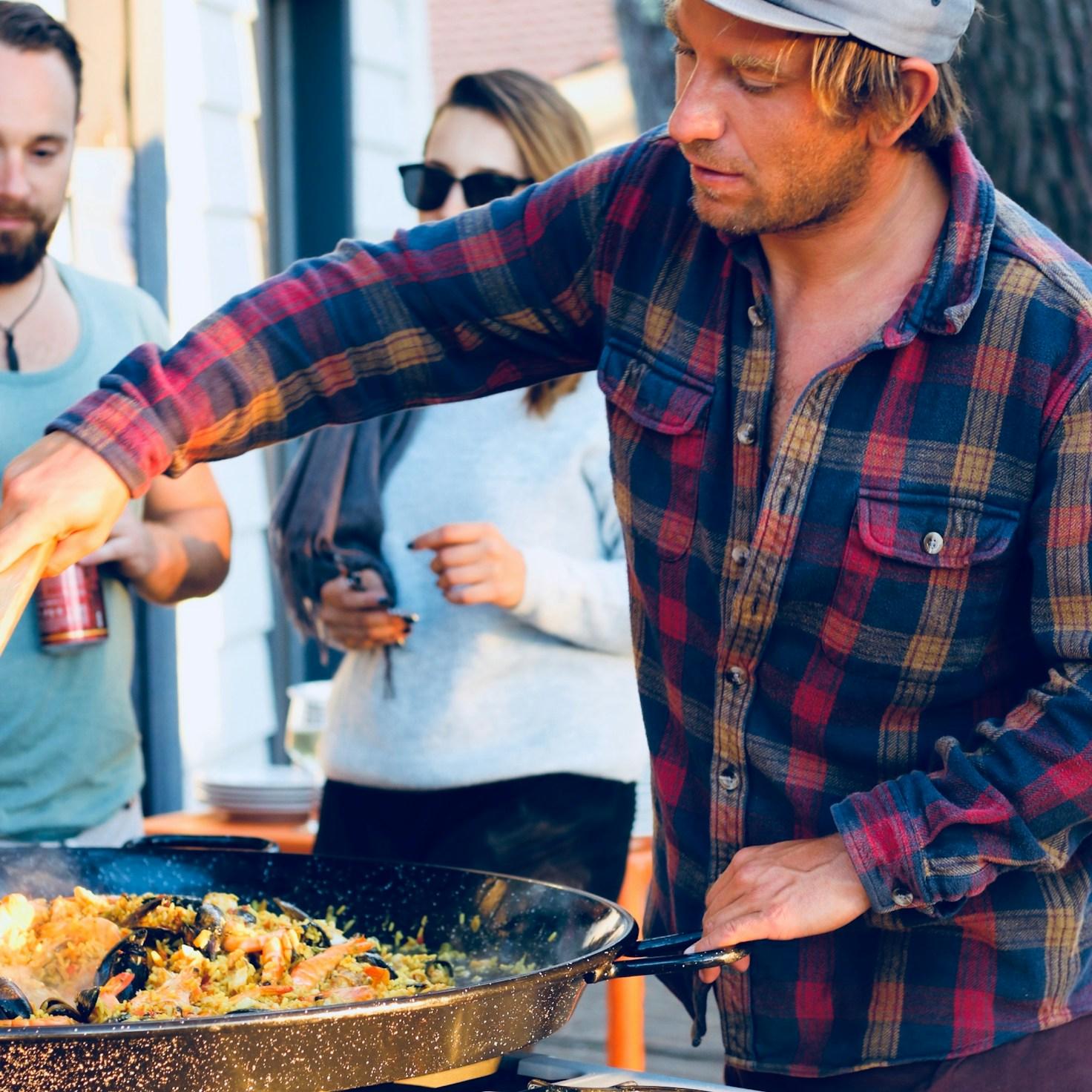 Friends collaborating in a modern kitchen space, swapping recipes and techniques